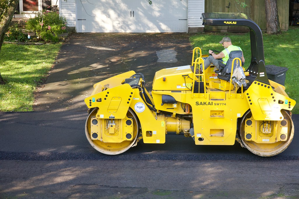 Tandem roller compacting a freshly laid asphalt surface